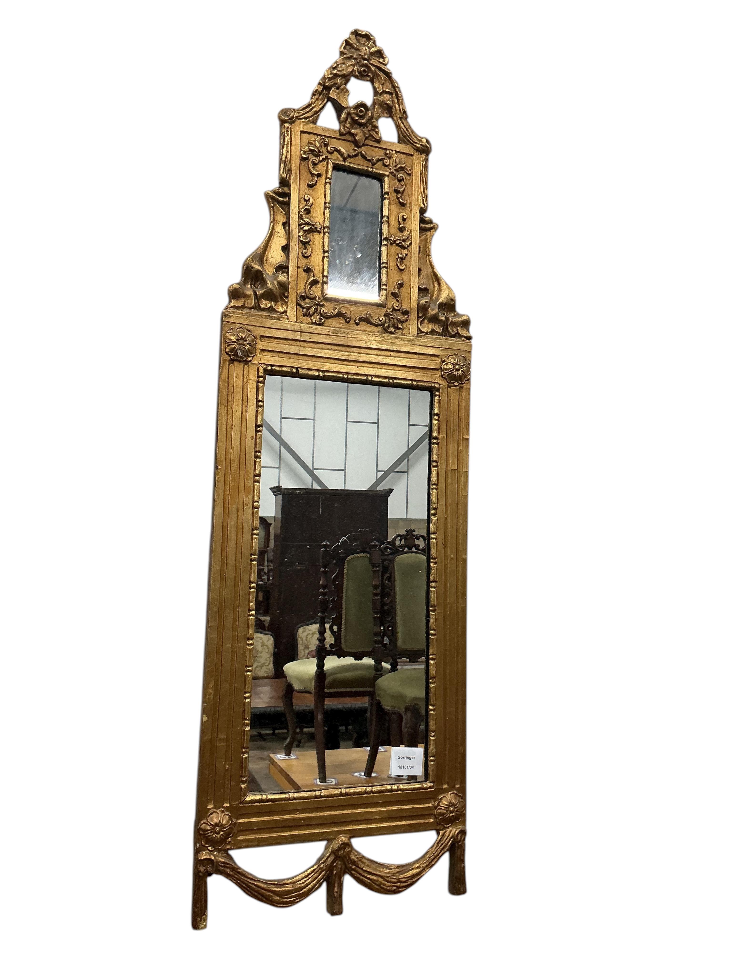A small carved giltwood and composition wall mirror, width 33cm, height 110cm